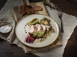 Detailaufnahme eines Tellergerichts im Restaurant Pfistermühle mit portionsweise aufgeschnittenen Filet-Stücken und dazu verschiedene Salate als Beilage.