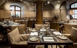 Stylishly set tables in the Pfistermühle restaurant of the Platzl Hotel.