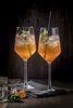 Aperitif at the Platzl Hotel Munich: Two white wine glasses with Aperol Spritz stand in front of a wooden wall